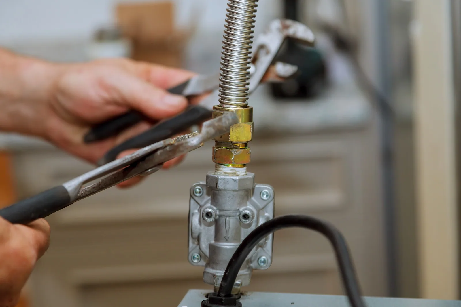 EP Plumbing, Heating & Air technician tightening the flexible gas connector at an appliance shut-off valve